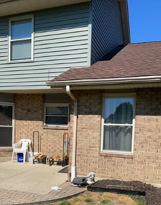 Two-story residential house with brick and vinyl siding exterior