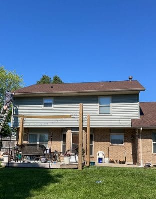 Two-story house with brick and vinyl siding under construction or renovation